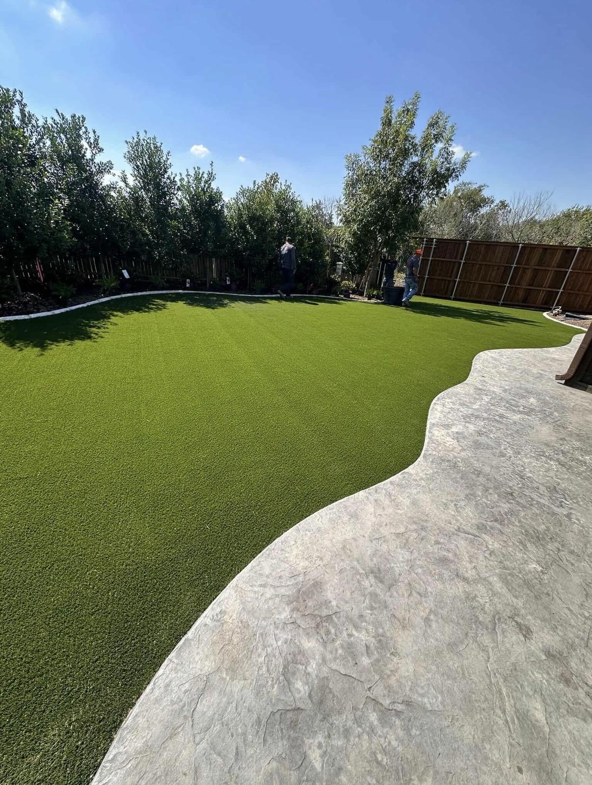 Aerial view of a modern backyard with pristine artificial turf